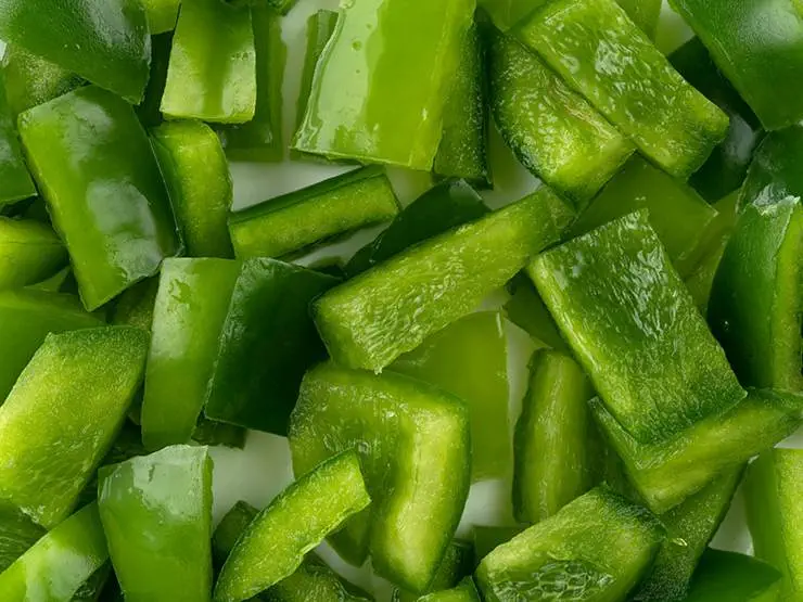 Chopped green bell peppers on a table